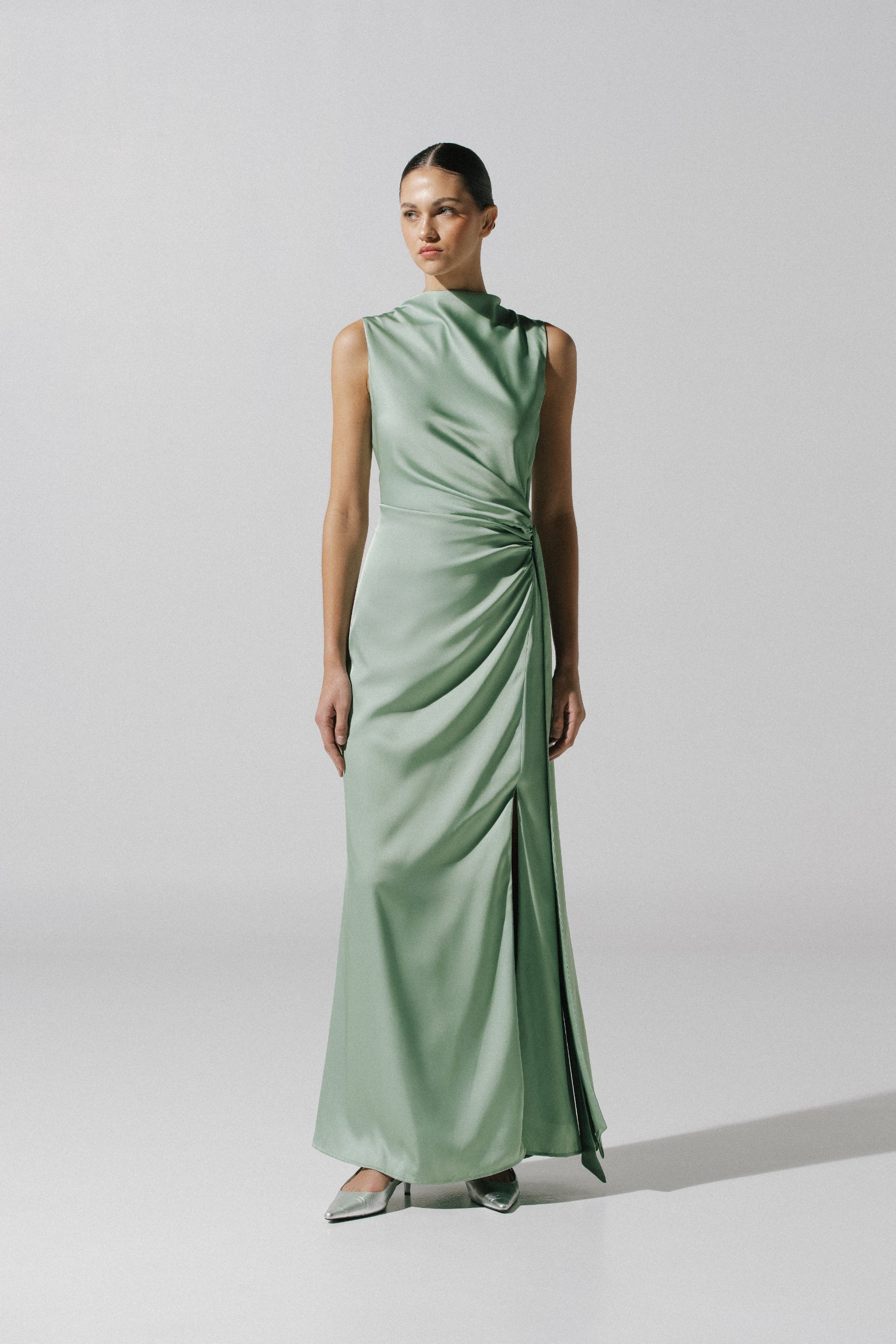 Model wearing the Baobab Vitto Maxi Dress in Jade color, with Halter Neckline and Draped front detail.