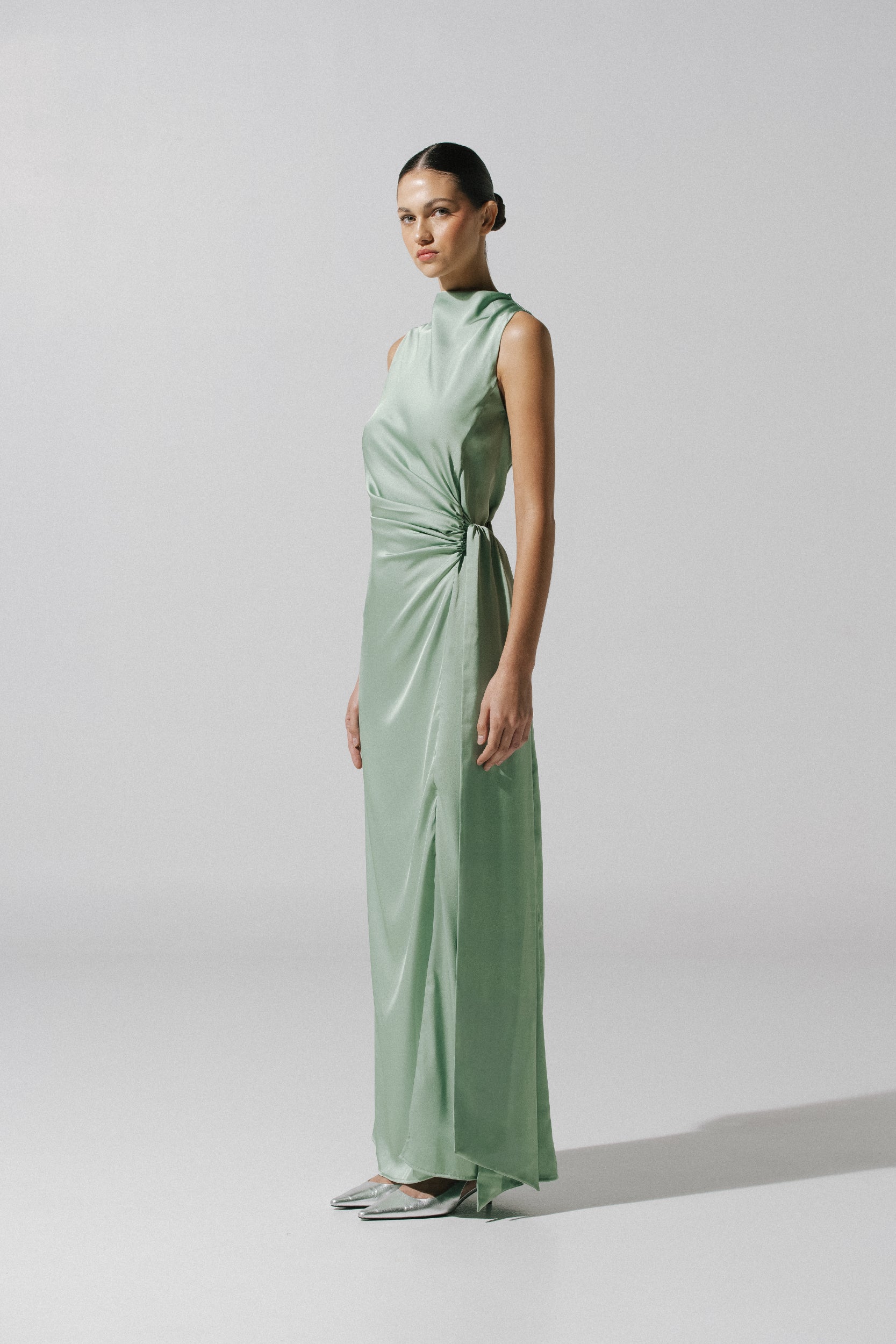 Model posing with the Baobab Vitto Maxi Dress in Jade color, highlighting the neckline and Draped detail.