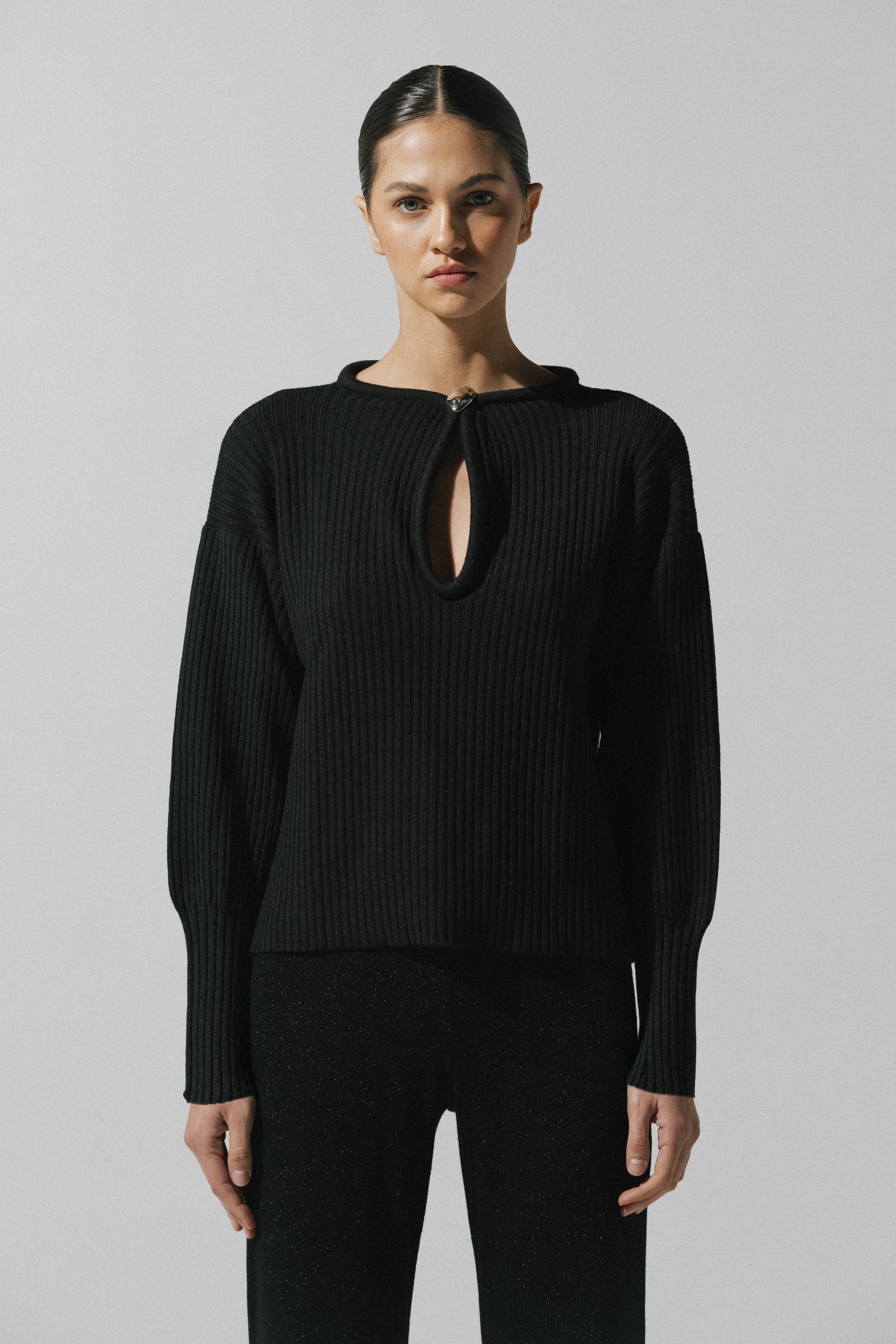 Akila Sweater by Baobab in black color, Round neckline with Front cutouts and Embellished hardware.