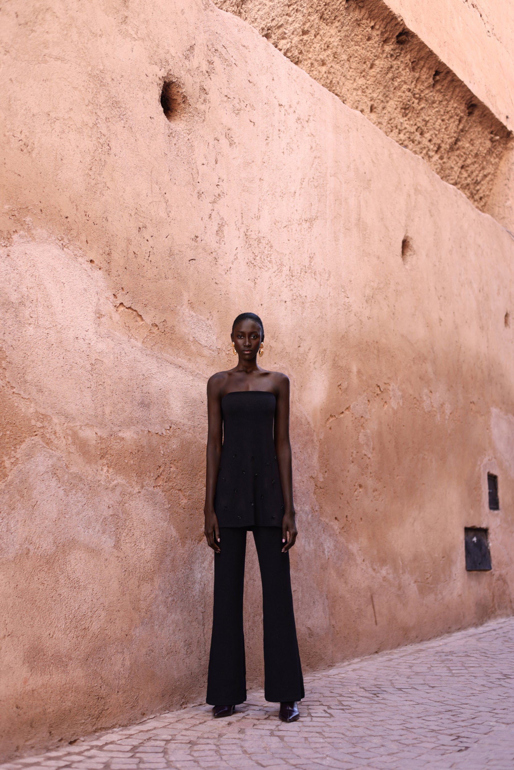 Detail of the Suzu Top in black Glossy fabric, Embellished and internal structure.
